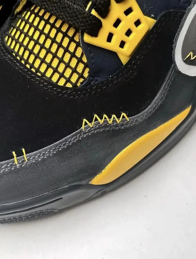 Close-up of a black and yellow sneaker on a white background