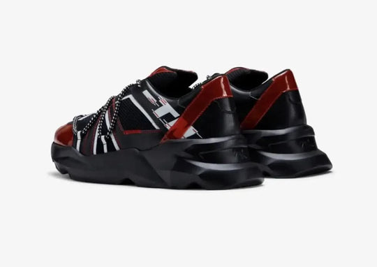 Black and red sneakers with a brand logo on a white background