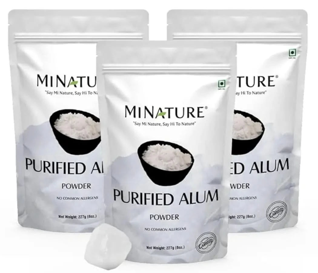Three packages of Minature Purified Alum Powder on a white background