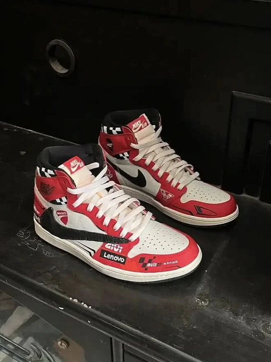 Red, white, and black high-top sneakers on a dark surface