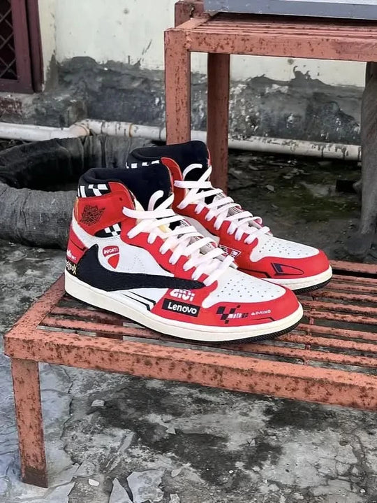 Red, white, and black sneakers on a rusted metal surface with a gritty background.