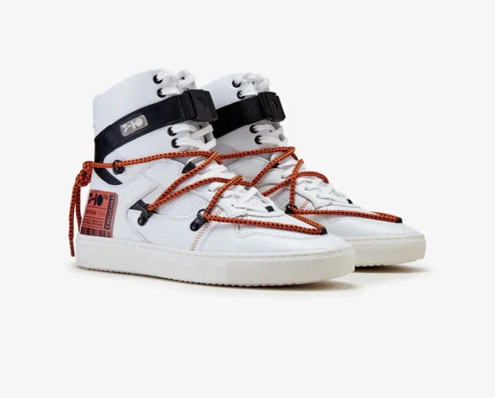 White high-top sneakers with orange laces and black straps on a white background
