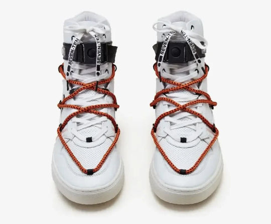 White high-top sneakers with orange laces on a white background